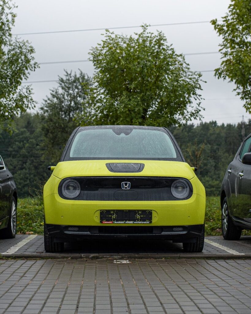a yellow car parked on a brick road